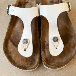 Woman’s Birkenstock white sandal 36/6 has piece of leather missing